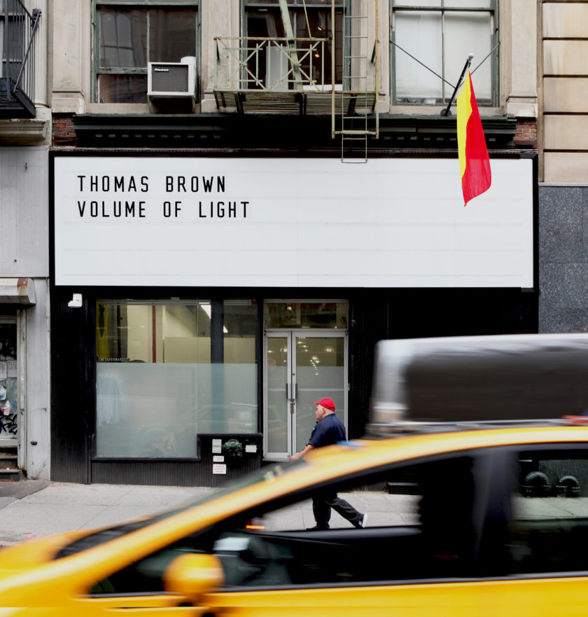 LUME Studios marquee at 393 Broadway reading Thomas Brown Volume of Light as a taxi passes