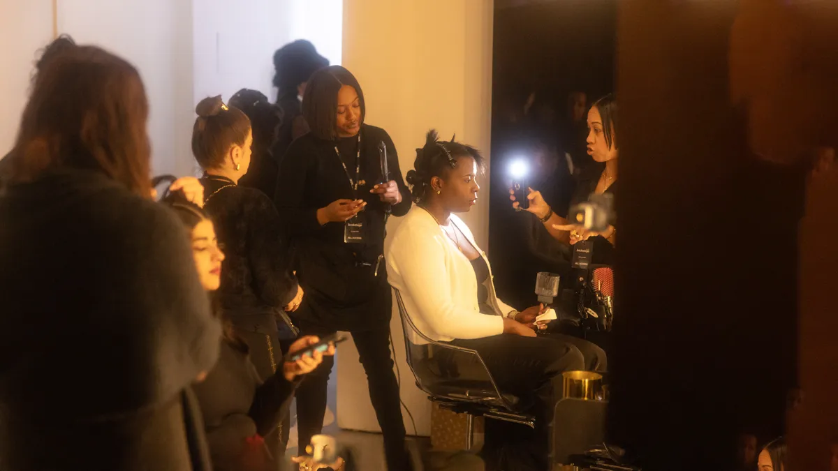 Stylists working on hair and makeup backstage at the TRESemme x NYFW event