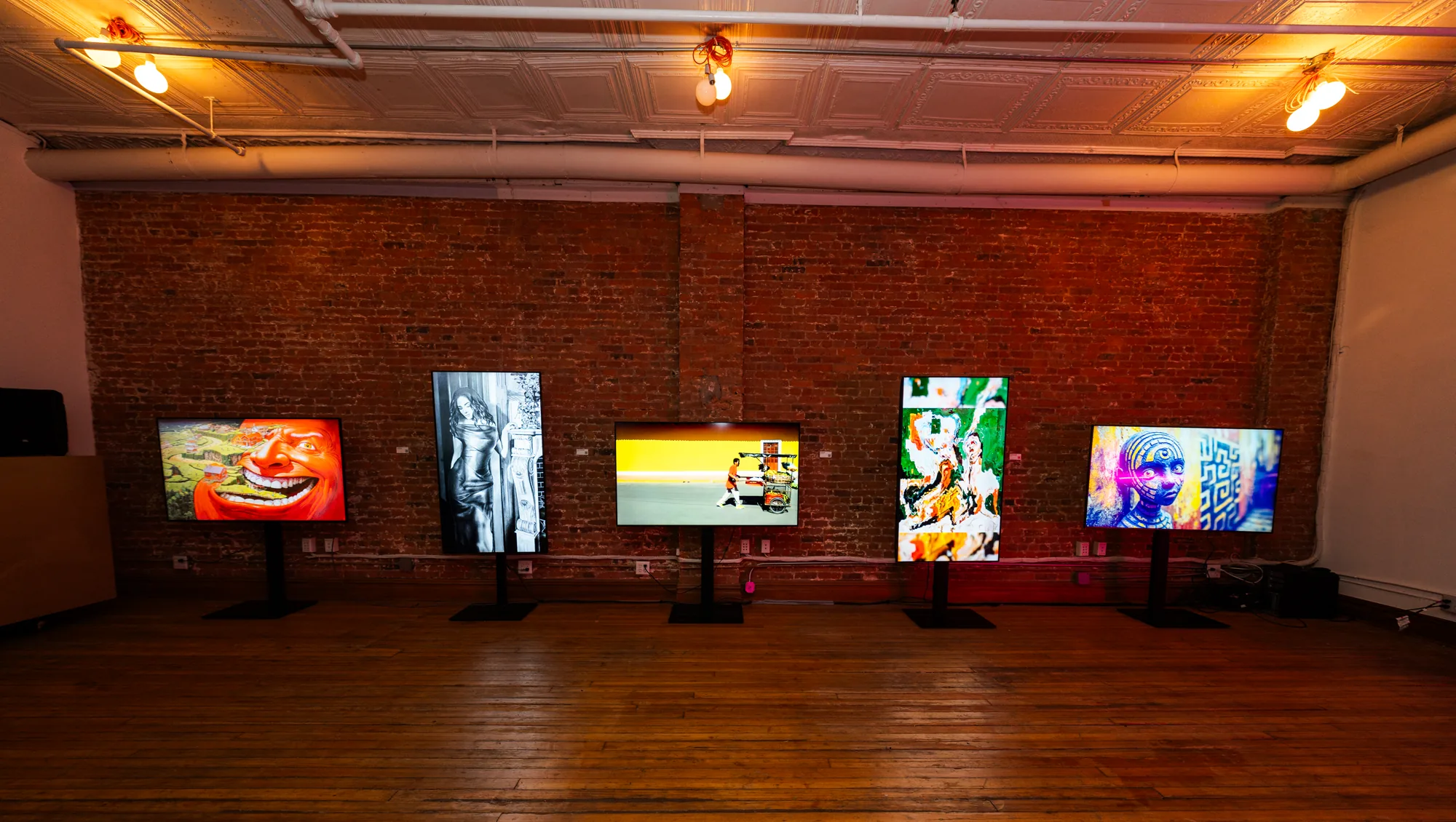 Digital art exhibition against exposed brick in LOFT 3