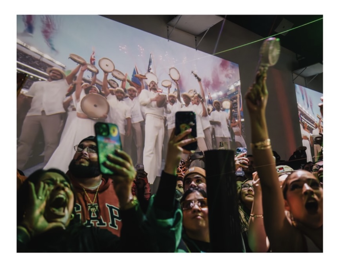 Crowd filming with phones as drummers fill a wraparound projection at LUME Studios