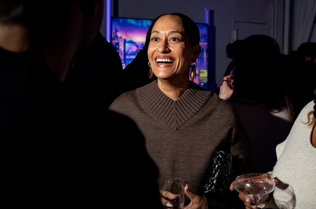 Guest smiling in conversation over drinks at the Roku executive dinner at LUME Studios