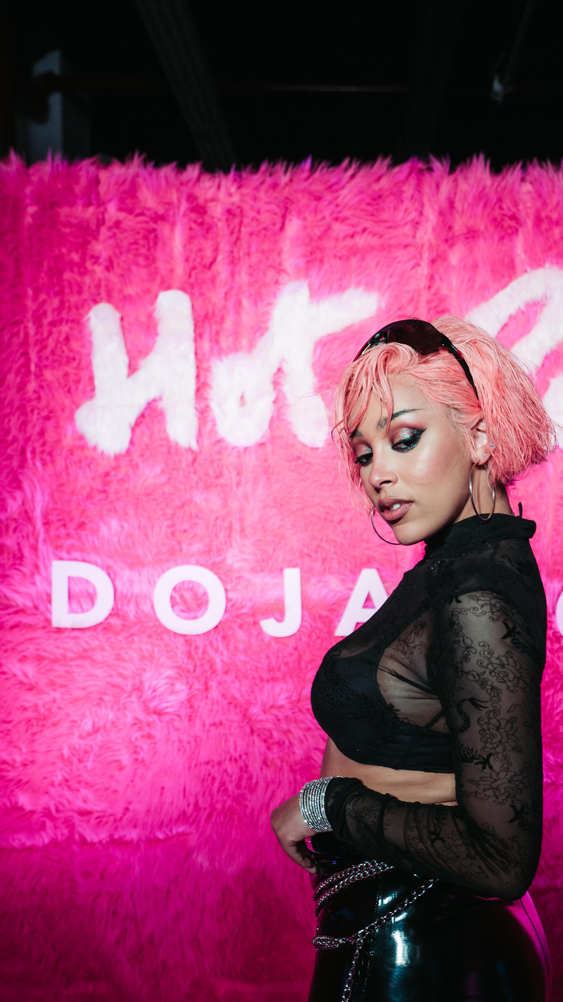Doja Cat posing in front of a pink fur Hot Pink backdrop at LUME Studios