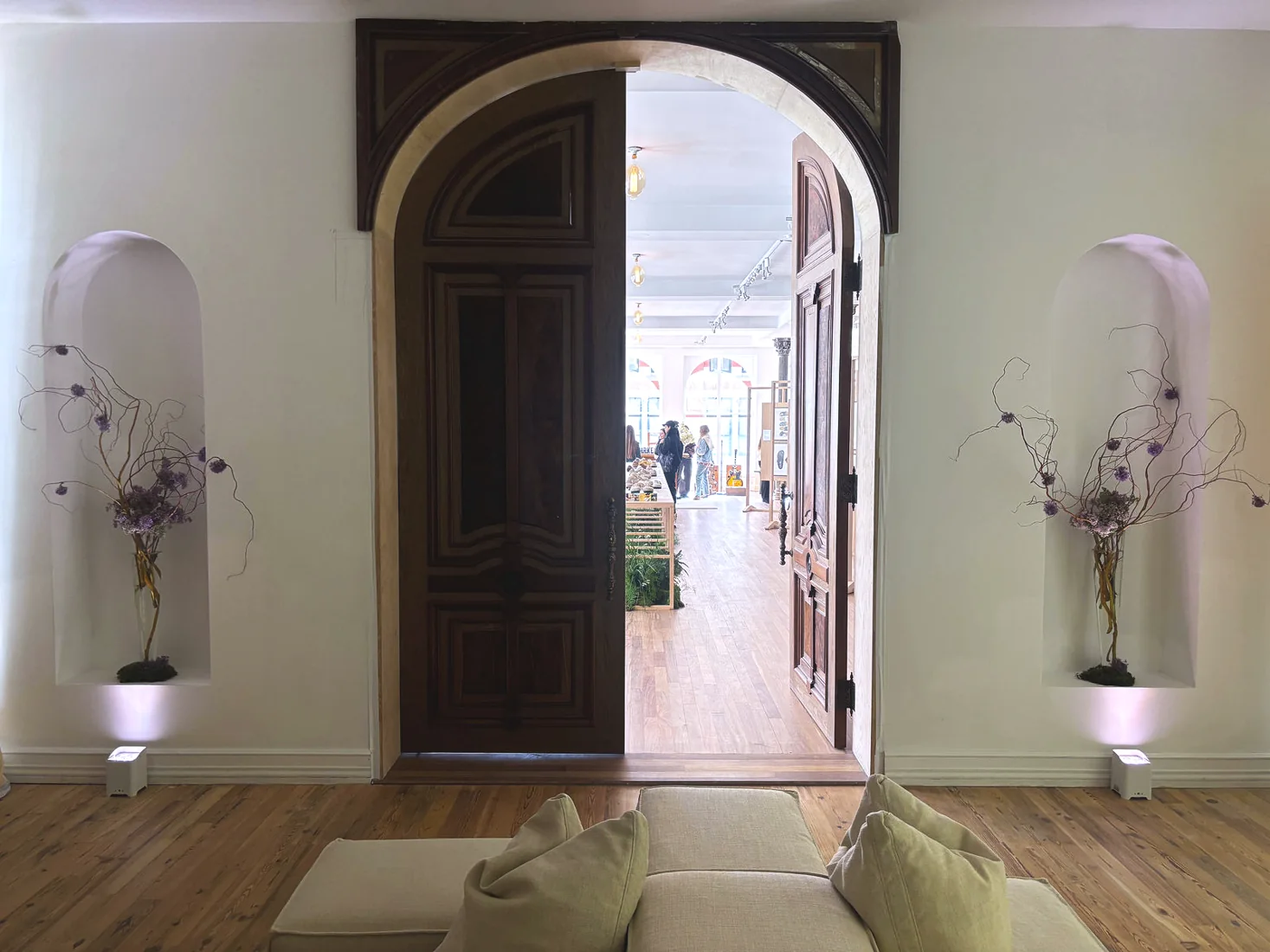 Birkenstock off-site showroom, arched entry with lit floral niches