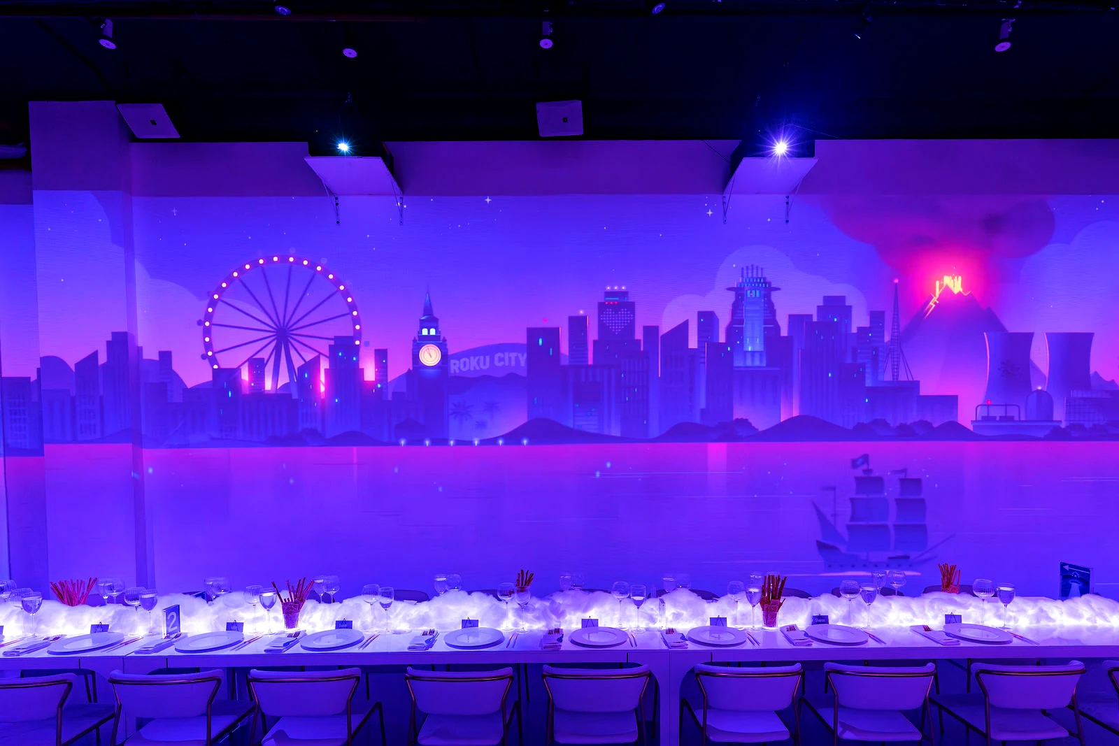 Roku executive dinner at LUME Studios, tables under the projected Roku City skyline