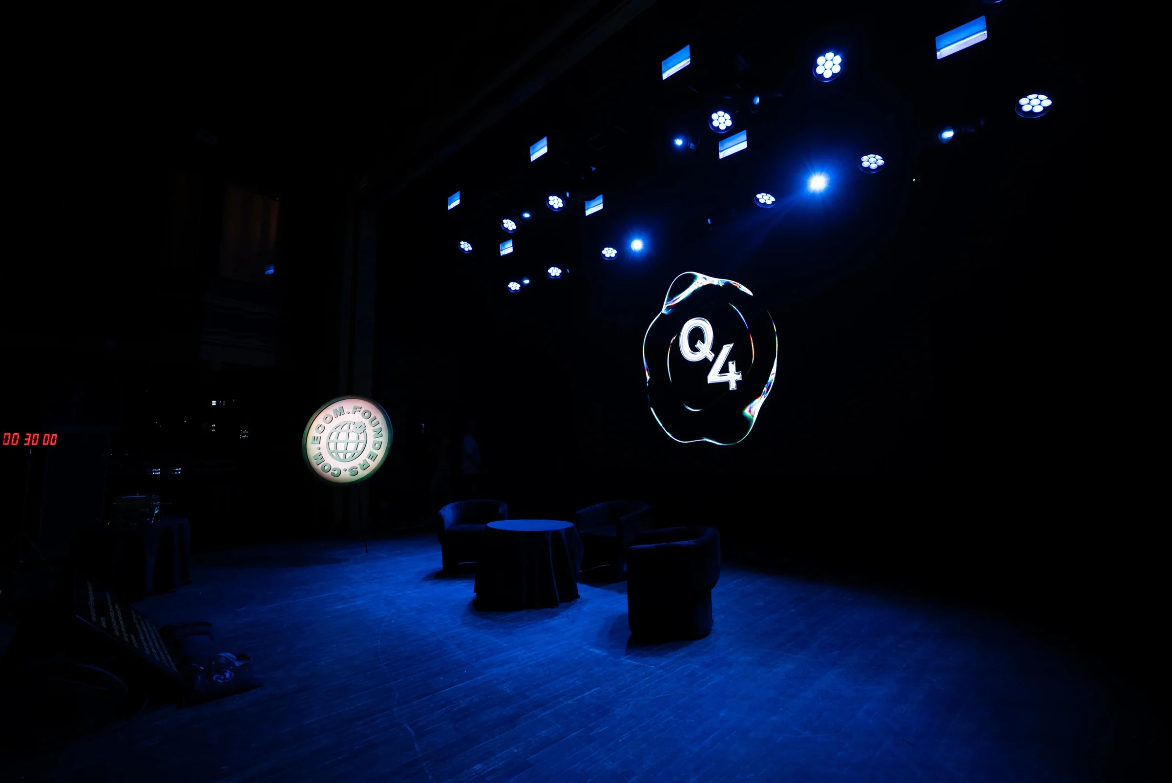 The Webster Hall stage set for the Q4 Summit, with the Q4 logo on the LED wall under blue stage lighting.