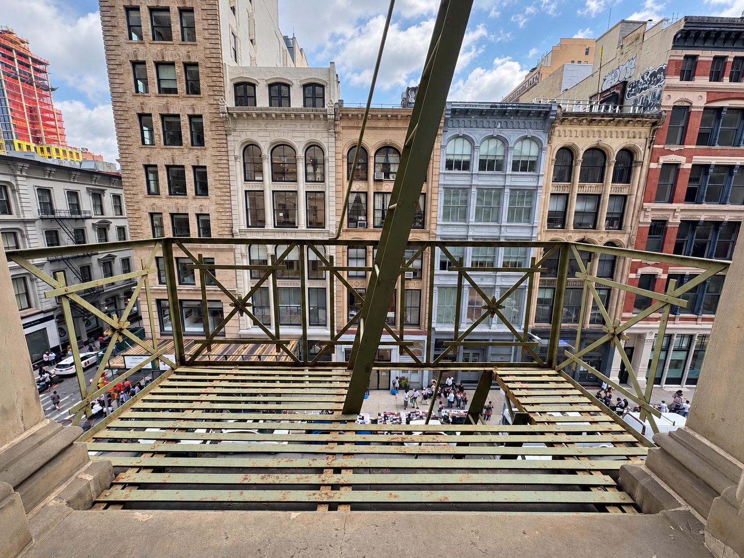 Fourth Floor Fire Escape at LUME Studios: gold cast iron railings and ladder over Broadway, 393 Broadway NYC
