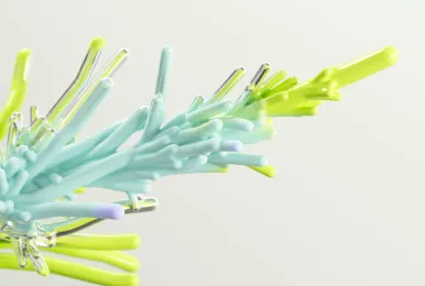 Abstract close-up of intertwined, colorful tubular structures in light blue, yellow, and purple on a white background.