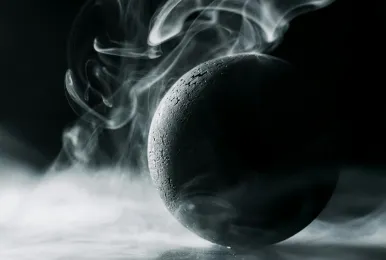 Black textured sphere surrounded by swirling white smoke on a dark background.