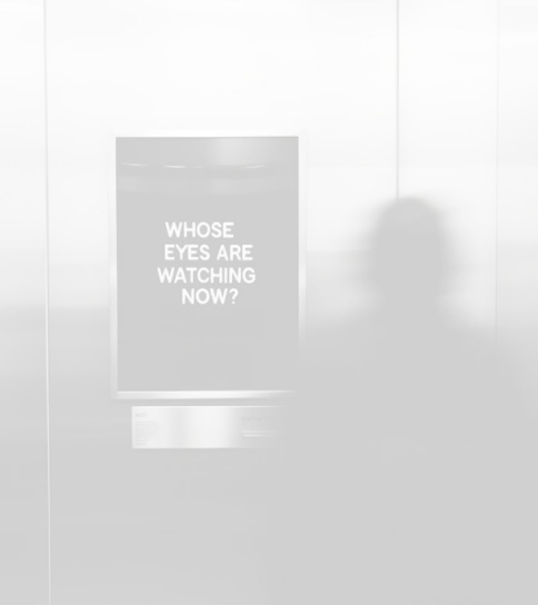 Blurred silhouette of a person looking at a sign that reads 'WHOSE EYES ARE WATCHING NOW?' on a metallic wall.