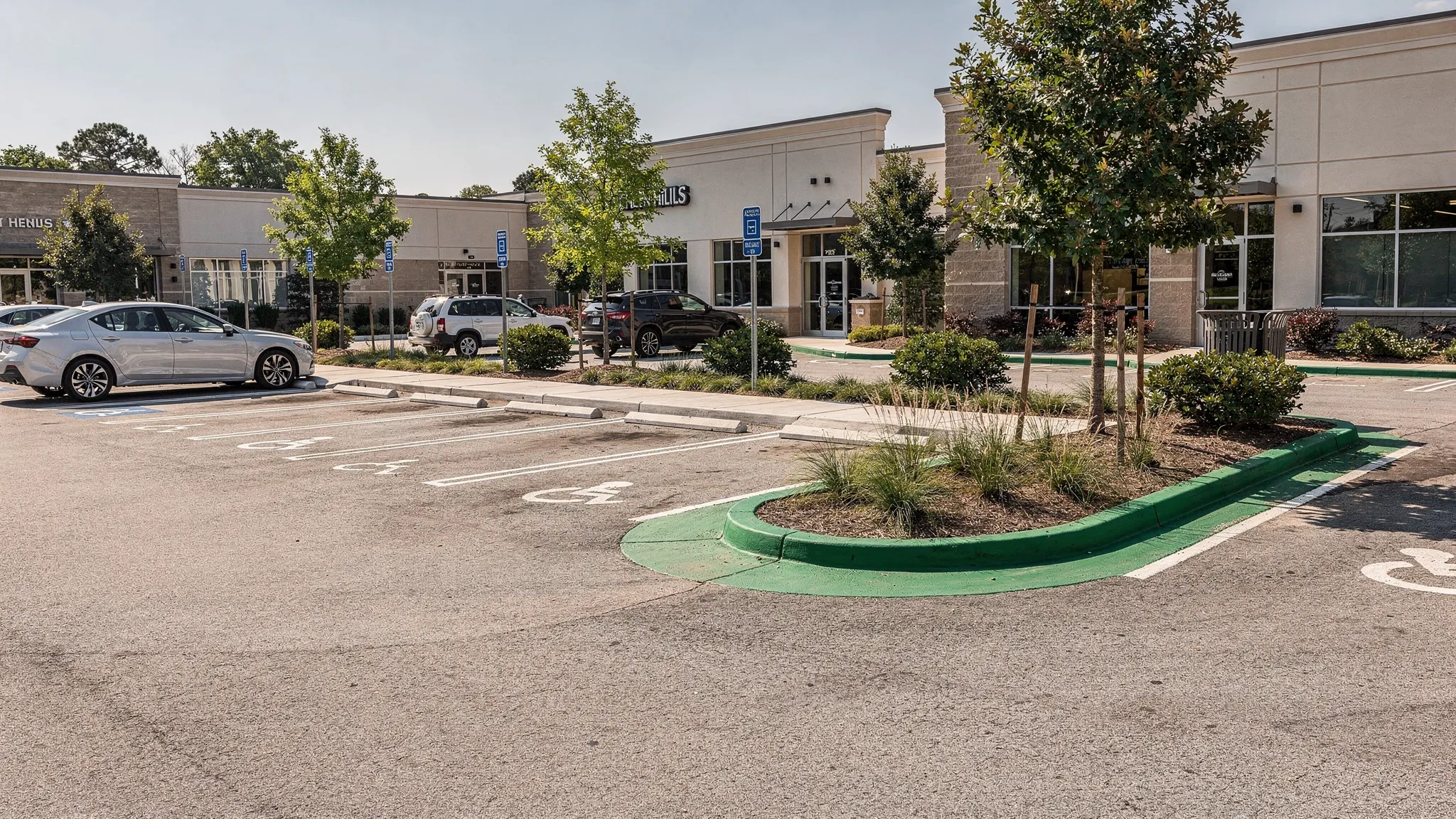 A clean commercial parking area in Green Hills with swept curb lines, clear sidewalks, landscaped edges, and well-maintained building entrances after routine exterior property care.