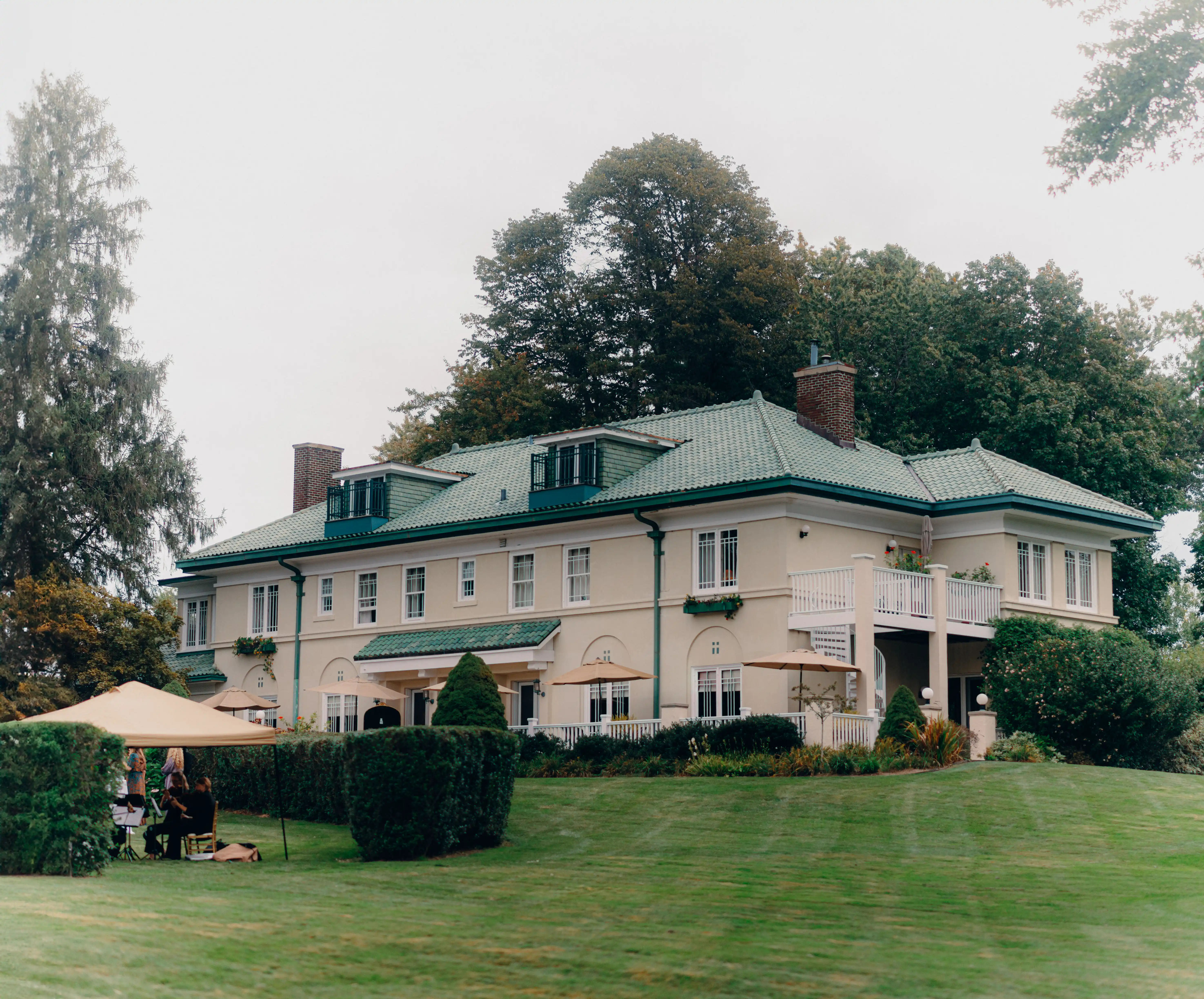 Exterior view of Belvedere Estate wedding venue in Saugatuck, Michigan, with manicured grounds and garden setup