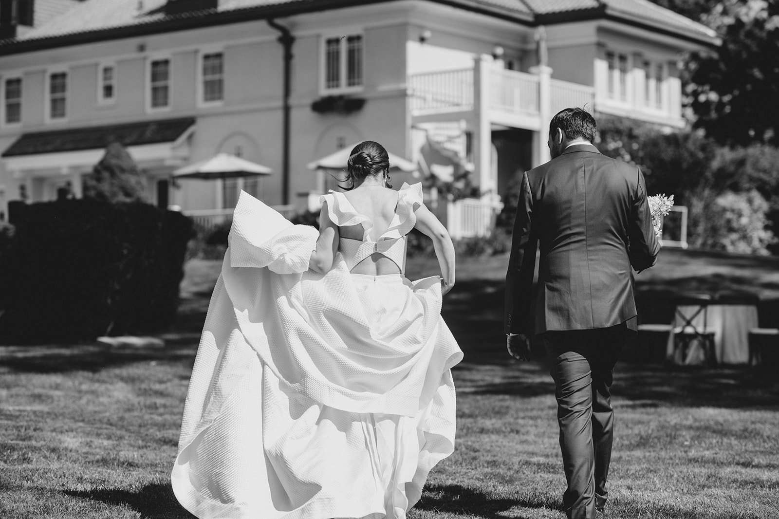 Vintage black and white photograph of a couple in front of Belvedere Estate mansion, early 1900s