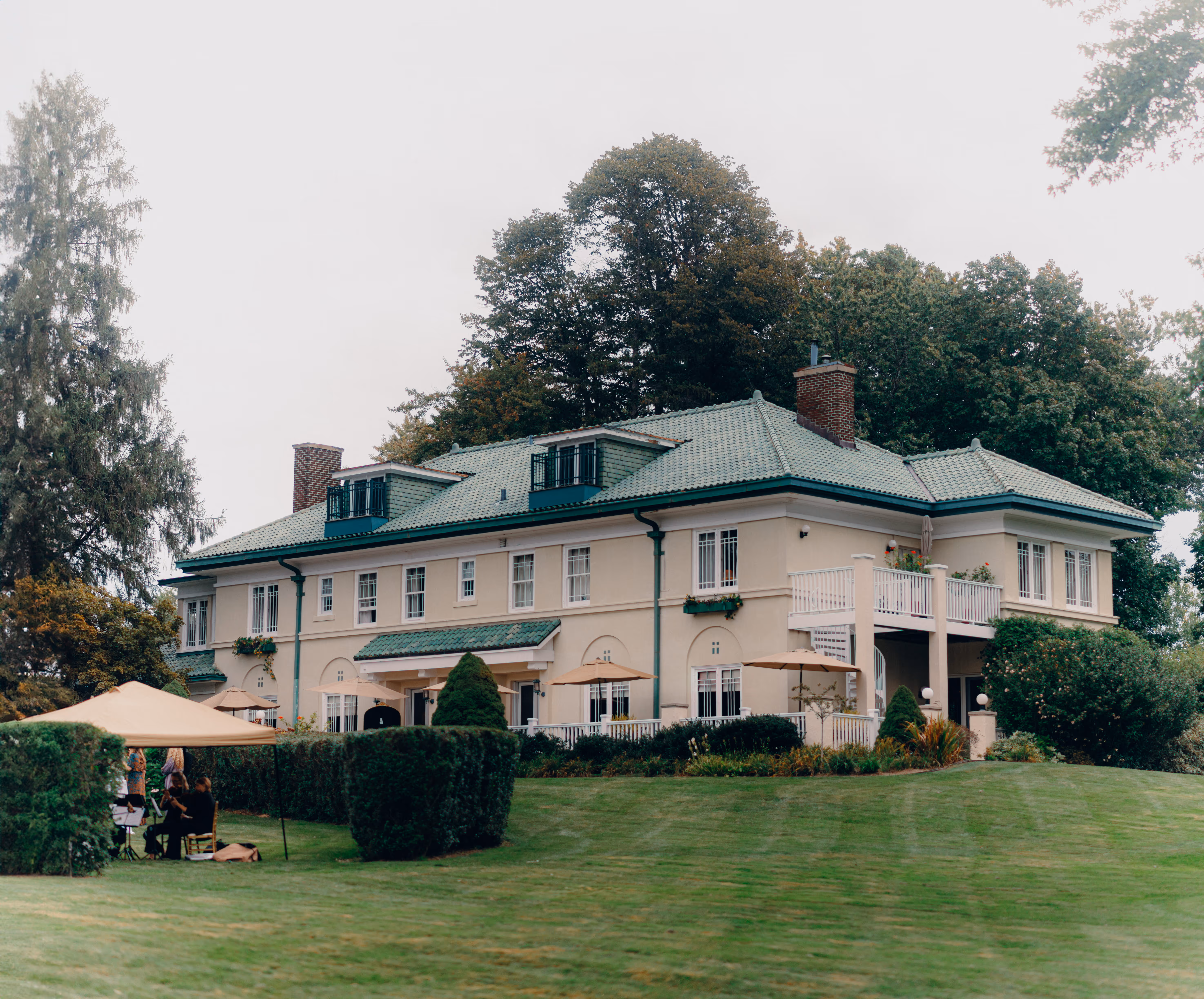 Belvedere Estate historic mansion exterior with wide manicured lawn on a sunny day in Saugatuck, Michigan