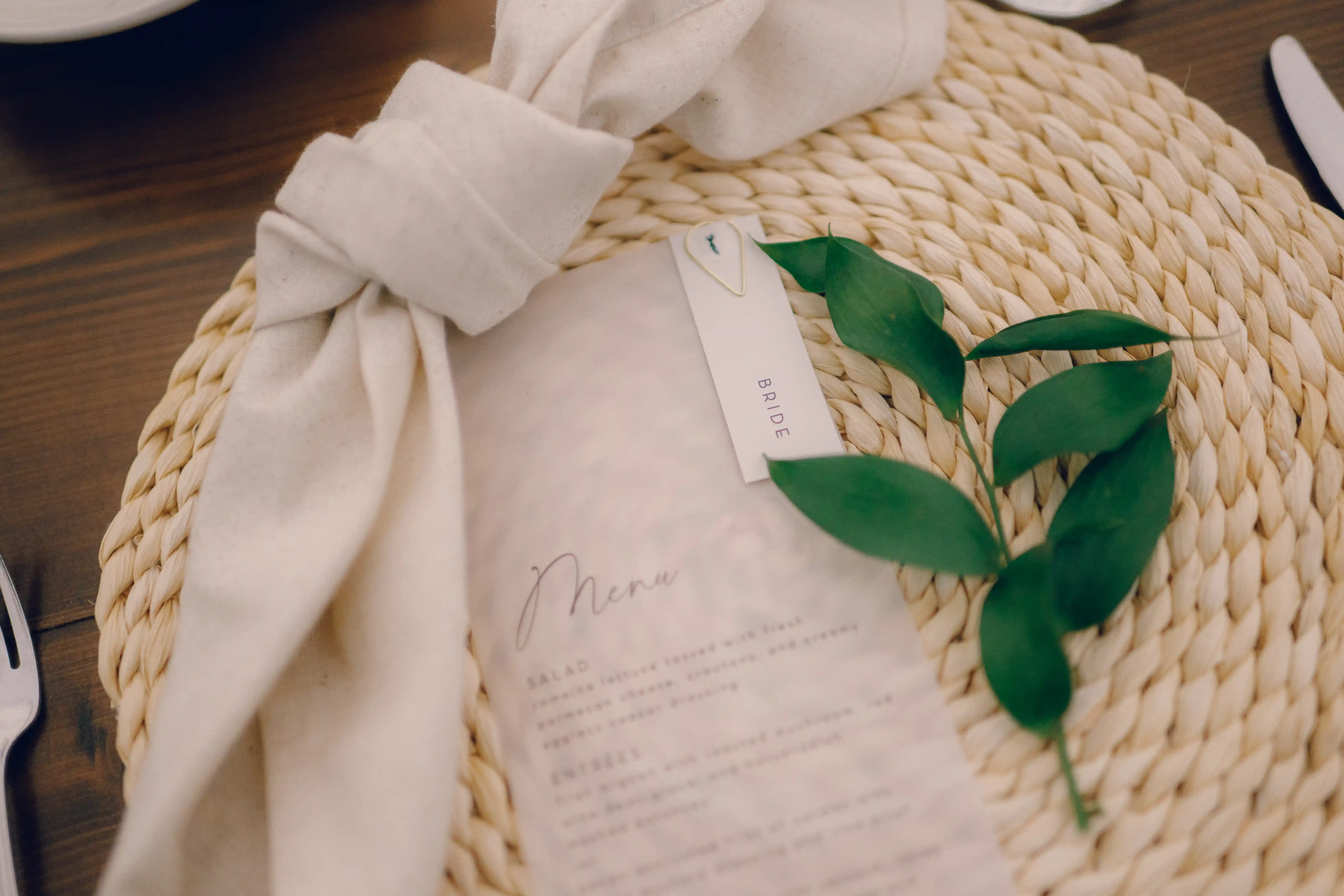 Close-up of botanical greenery wedding detail on linen at Belvedere Estate
