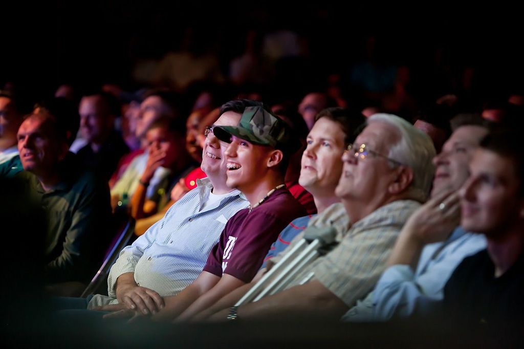 Audience laughing together at a Nazareth comedy show