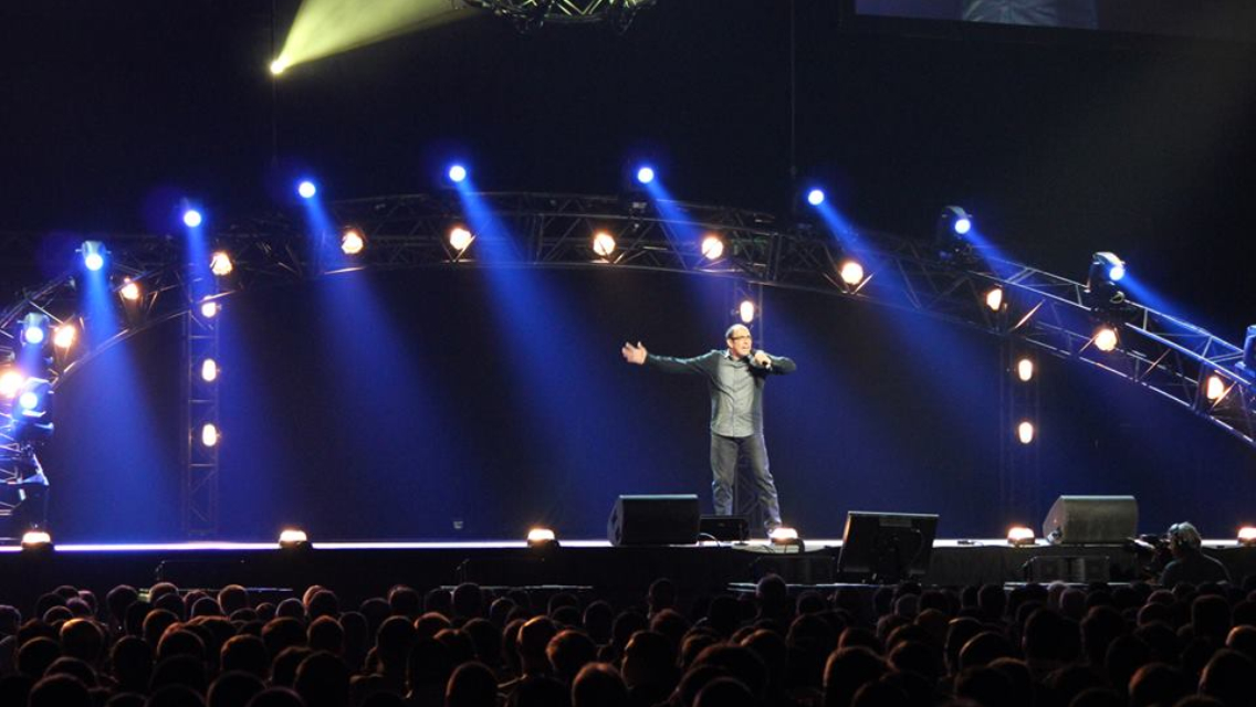 Blue lit stage setup during a Nazareth live comedy performance