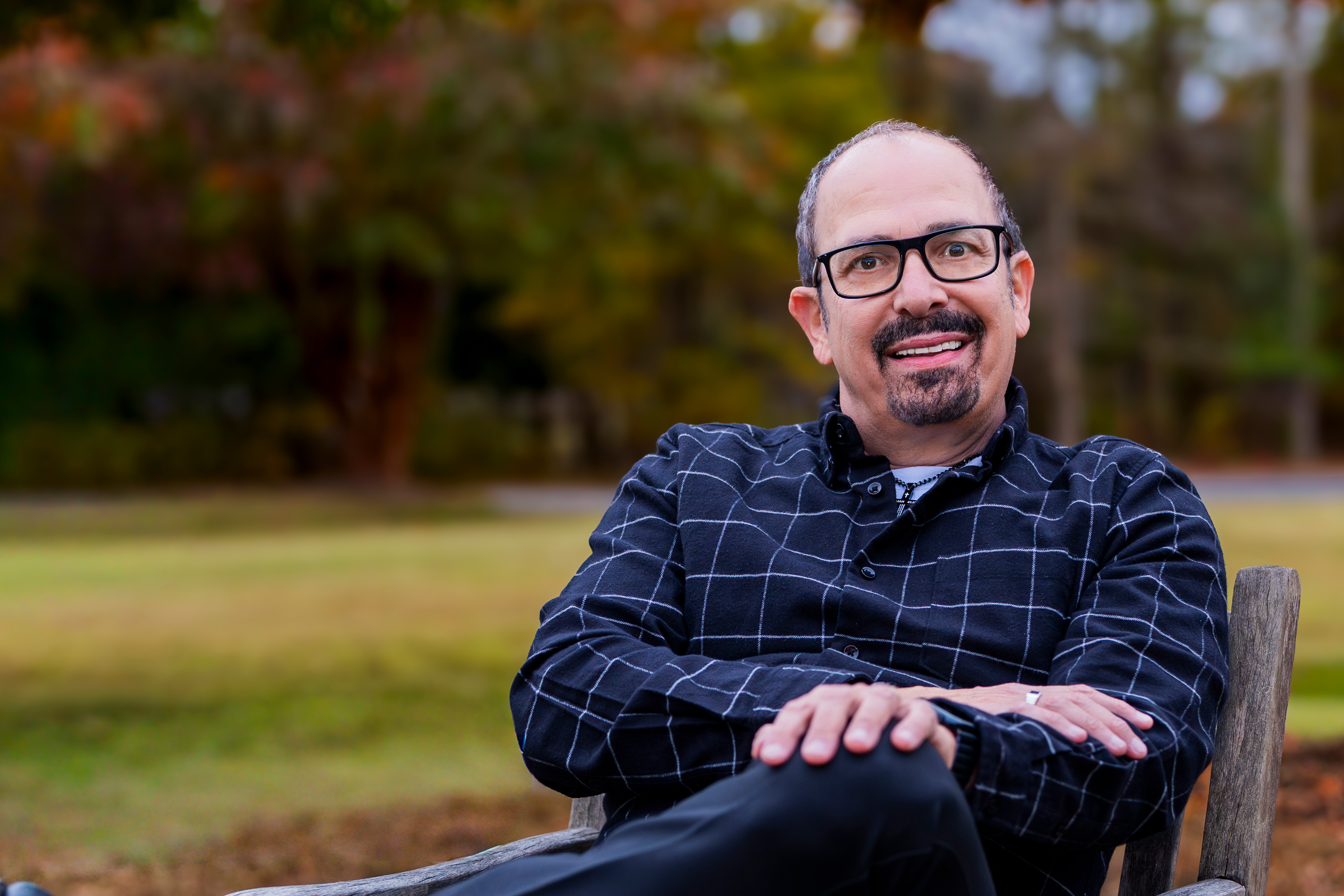 Nazareth laughing mid joke during a standup comedy set