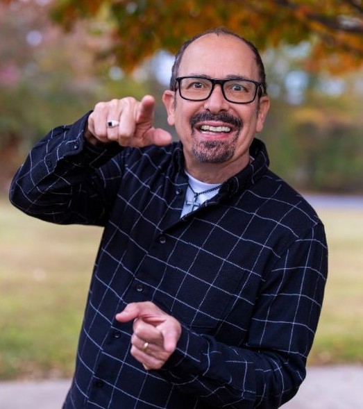 Nazareth smiling and posing confidently for promotional comedy photography