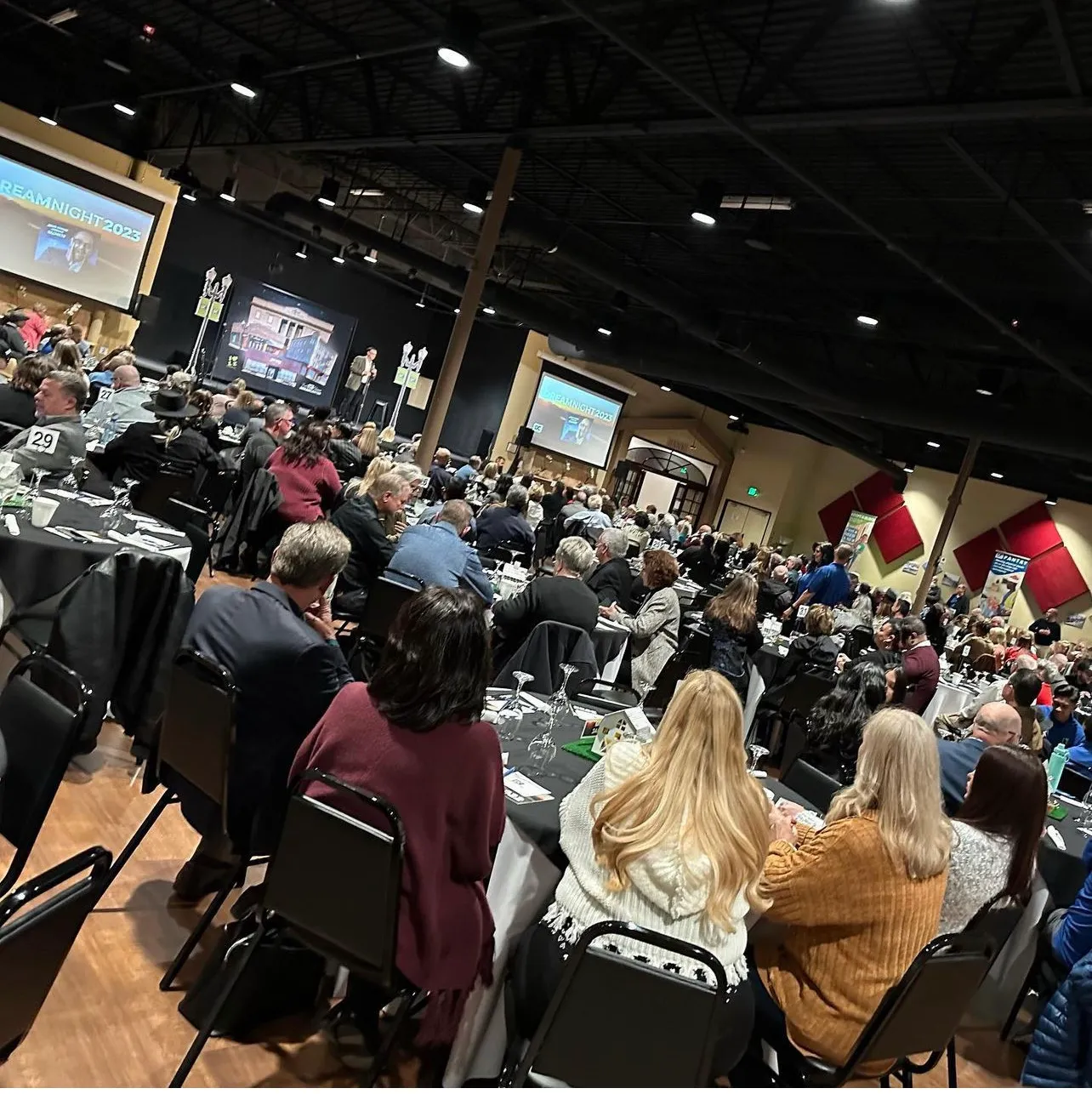 Live comedy audience at a packed conference show featuring comedian Nazareth