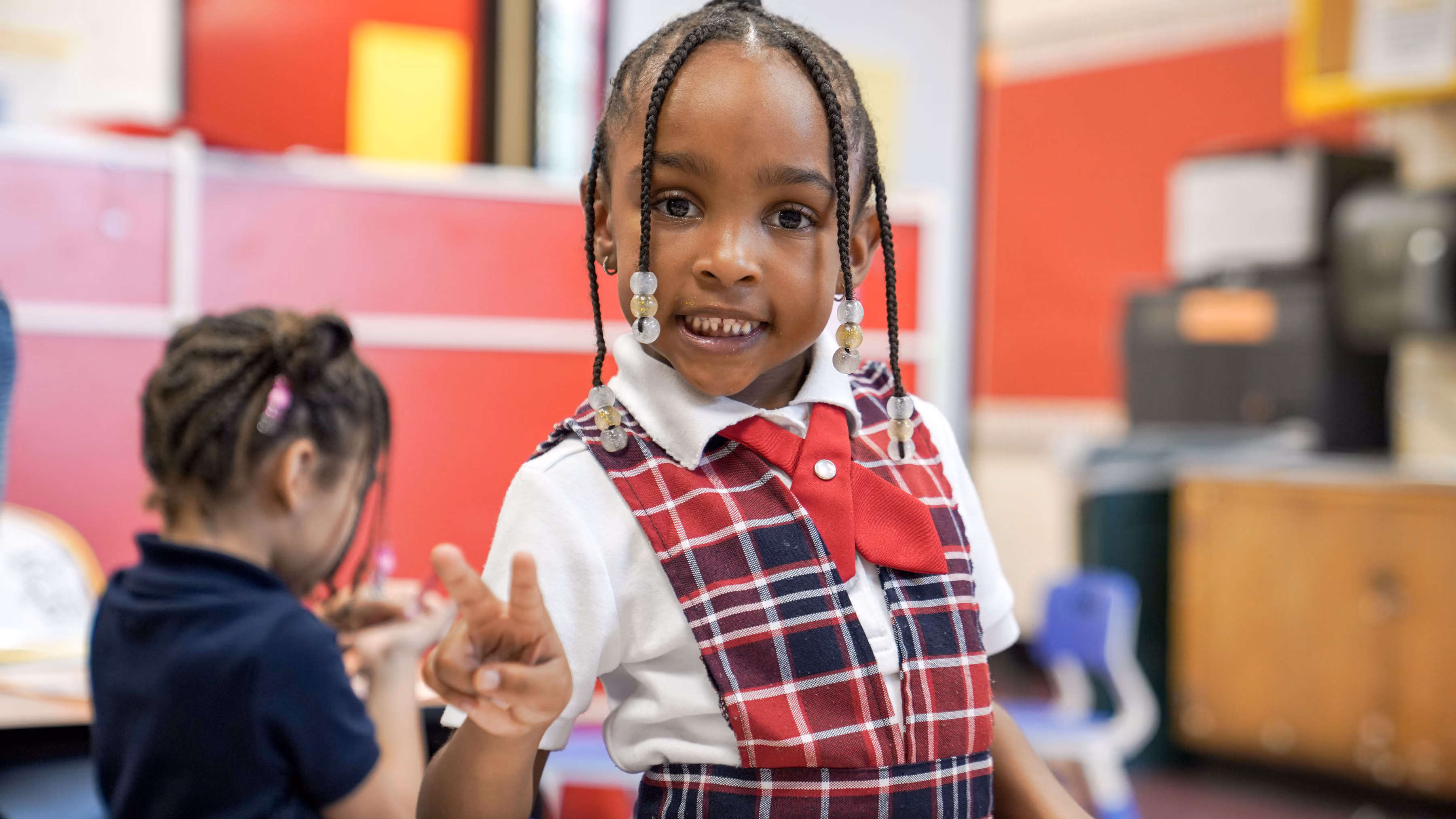 Smiling young student in school uniform inside a classroom