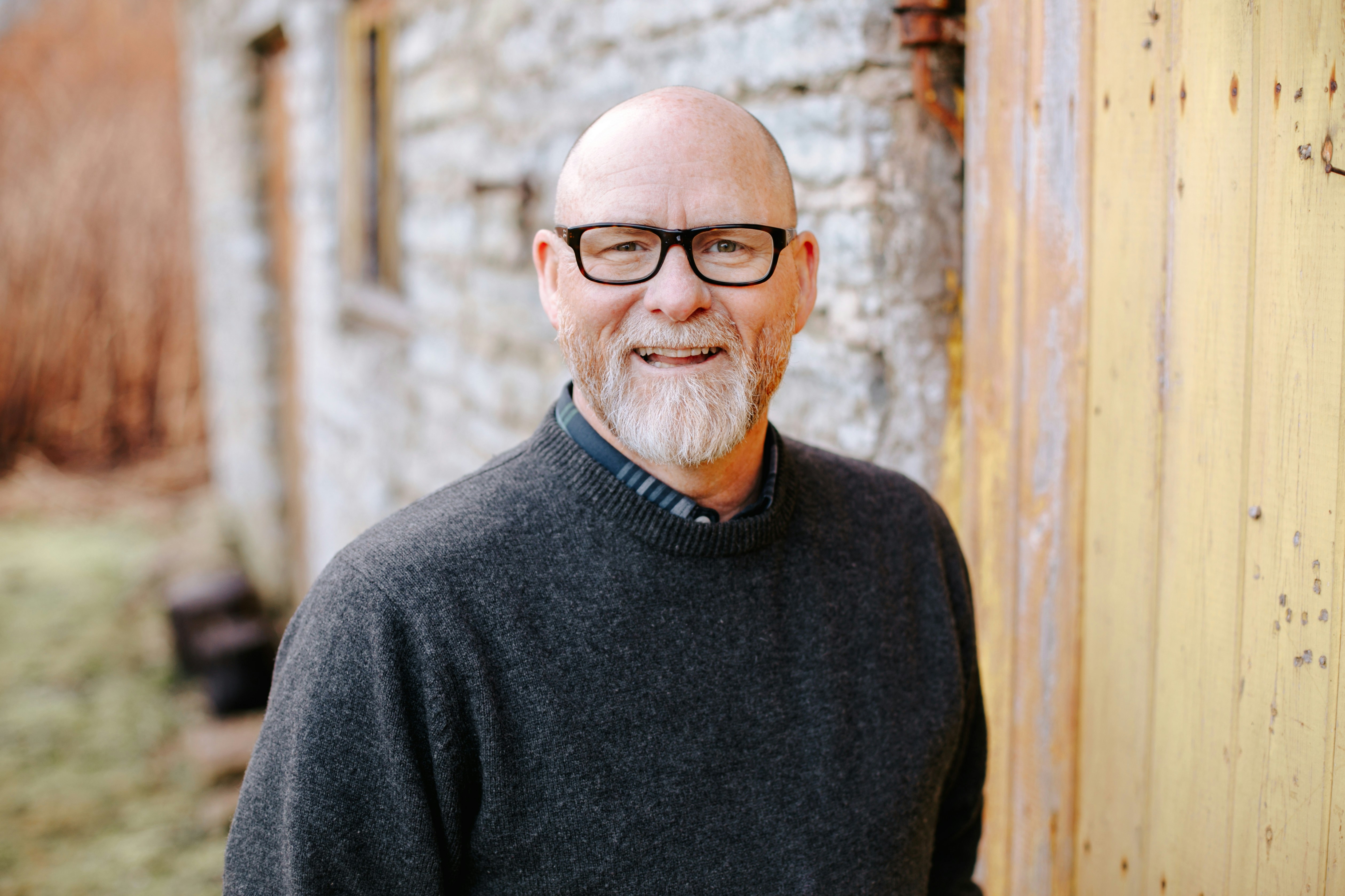Portrait of a SNAXX customer smiling outdoors in a casual environment.