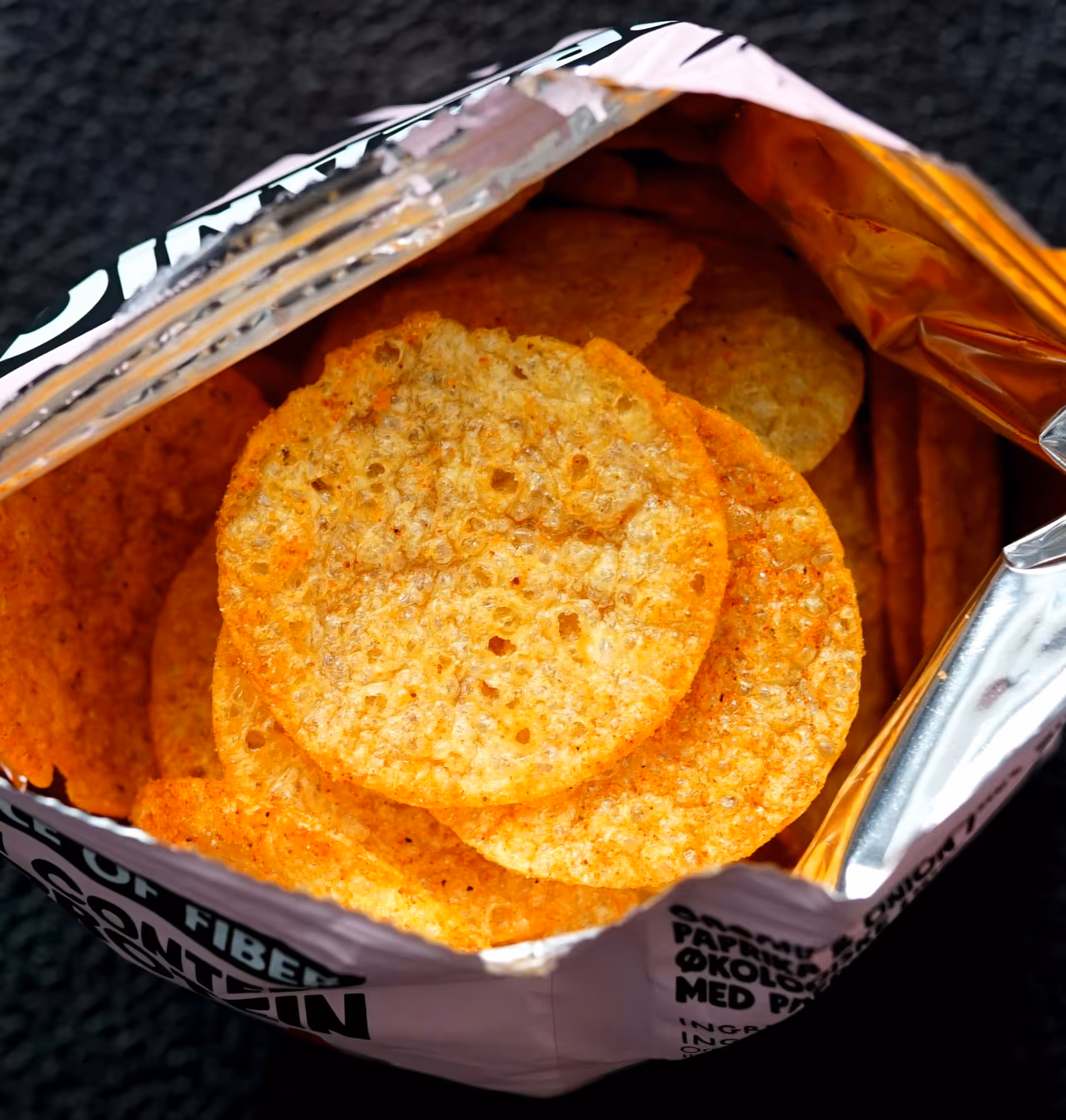 Close-up view of SNAXX baked potato chips inside an open bag.