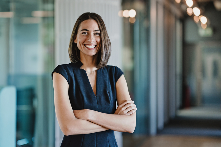 Portrait of a smiling person sitting at a desk