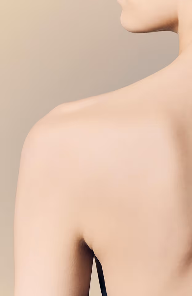 Close-up of a person's bare shoulder and neck against a soft beige background.