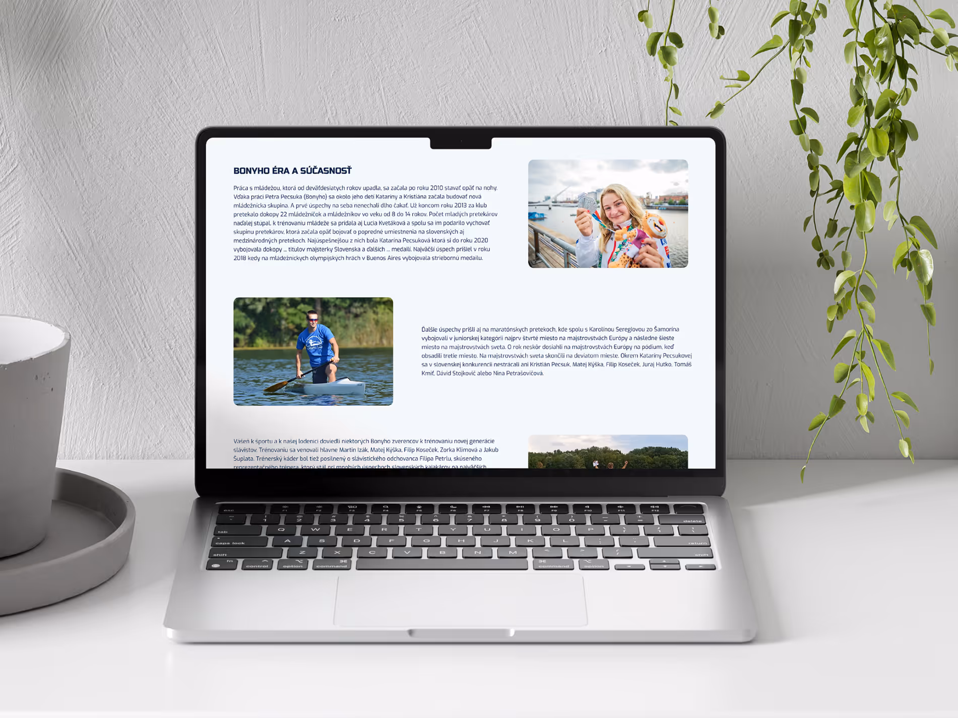 Open laptop on a white desk displaying a webpage in Slovak with text and photos including a woman holding medals and a person rowing on water.