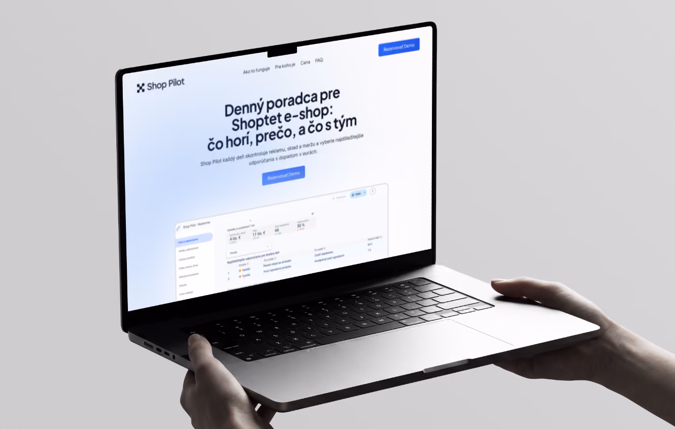 Hands holding a laptop showing Shop Pilot dashboard in Slovak for managing Shoptet e-shop issues.