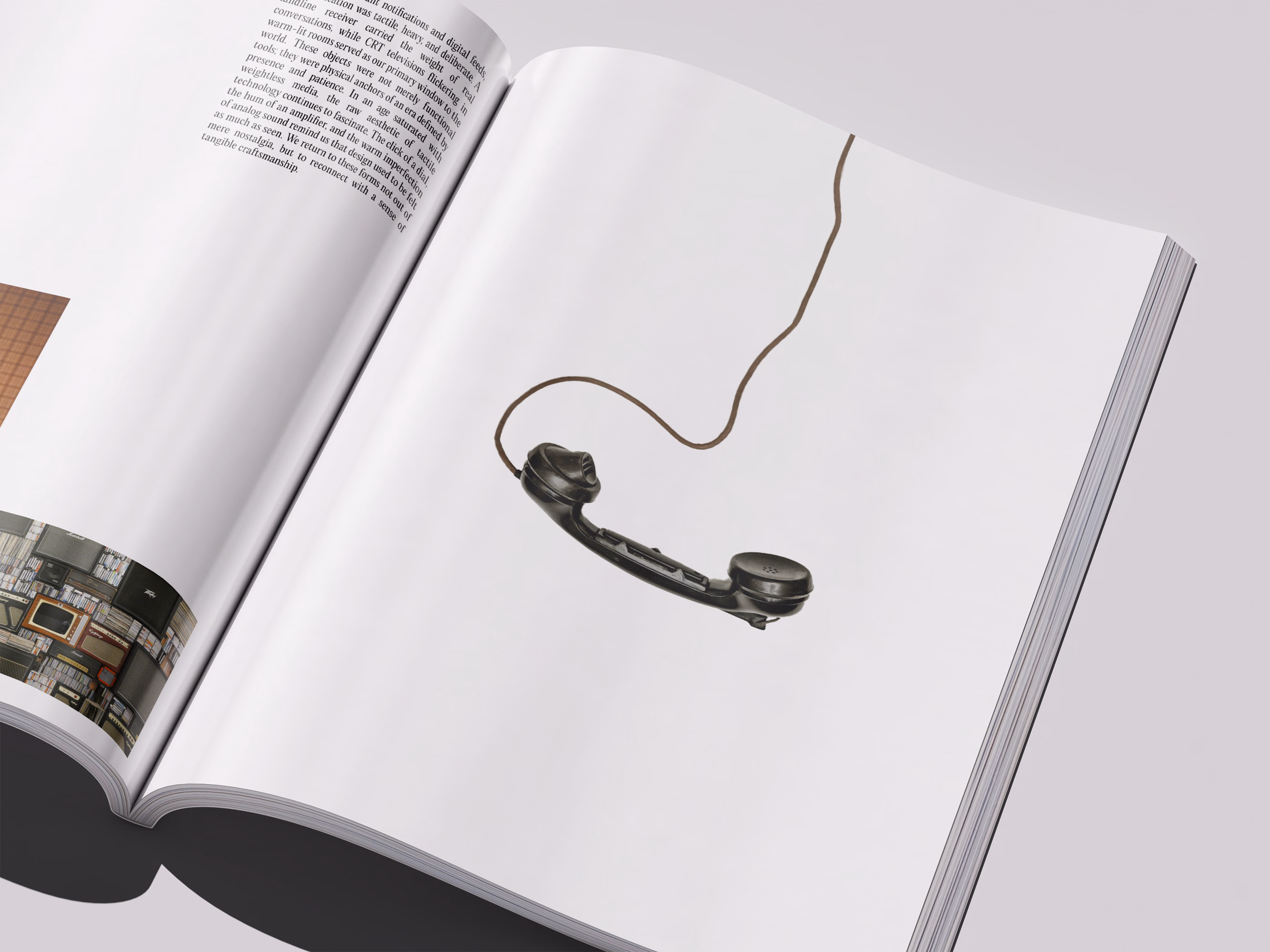 Open magazine showing a vintage black telephone handset with a coiled cord on a white page, with text and a photo visible on the left page.