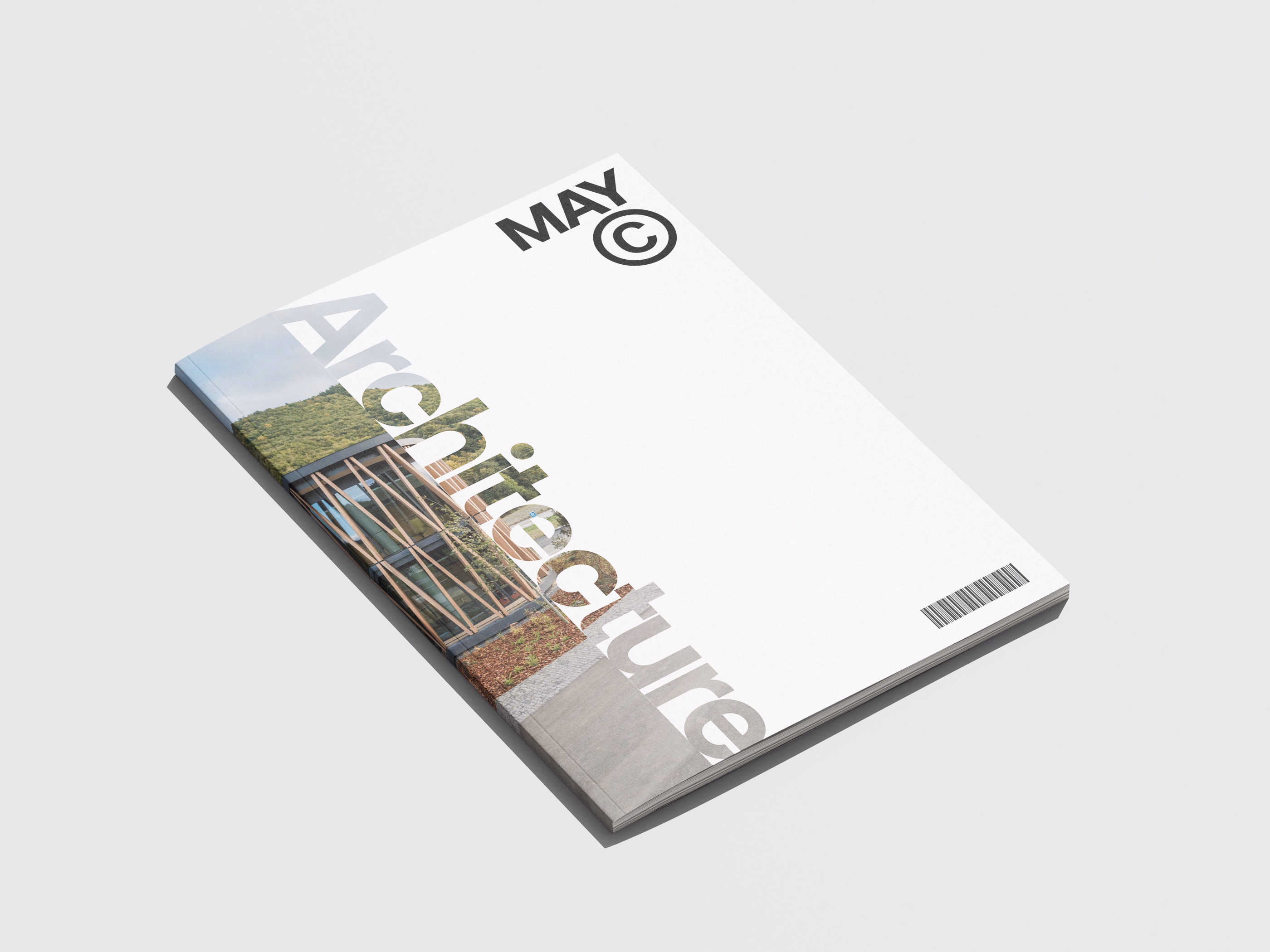 Magazine titled 'Architecture' with a modern building and greenery visible through the translucent title text on a white cover, marked with 'MAY' and a copyright symbol at the top.