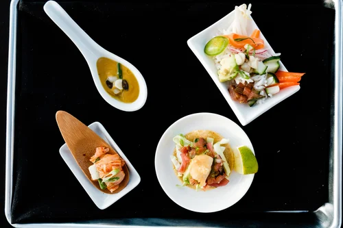 BlueNalu's whole-muscle, cell-based yellowtail prepared in four different recipes (clockwise from top left): roasted butternut squash & yellowtail bisque, poke bowl, fish taco, and kimchi.