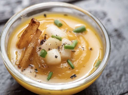 BlueNalu's whole-muscle, cell-based yellowtail medallions atop a bisque of roasted butternut squash.