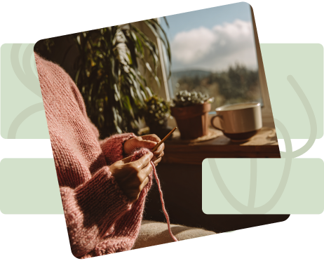 A woman in a pink sweater knitting