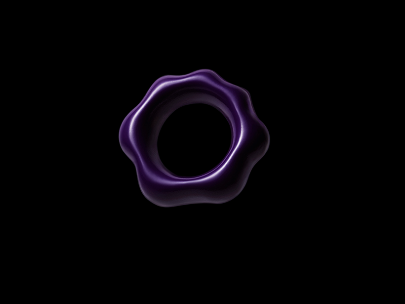 Shiny purple torus-shaped object with smooth wave-like edges on a black background.