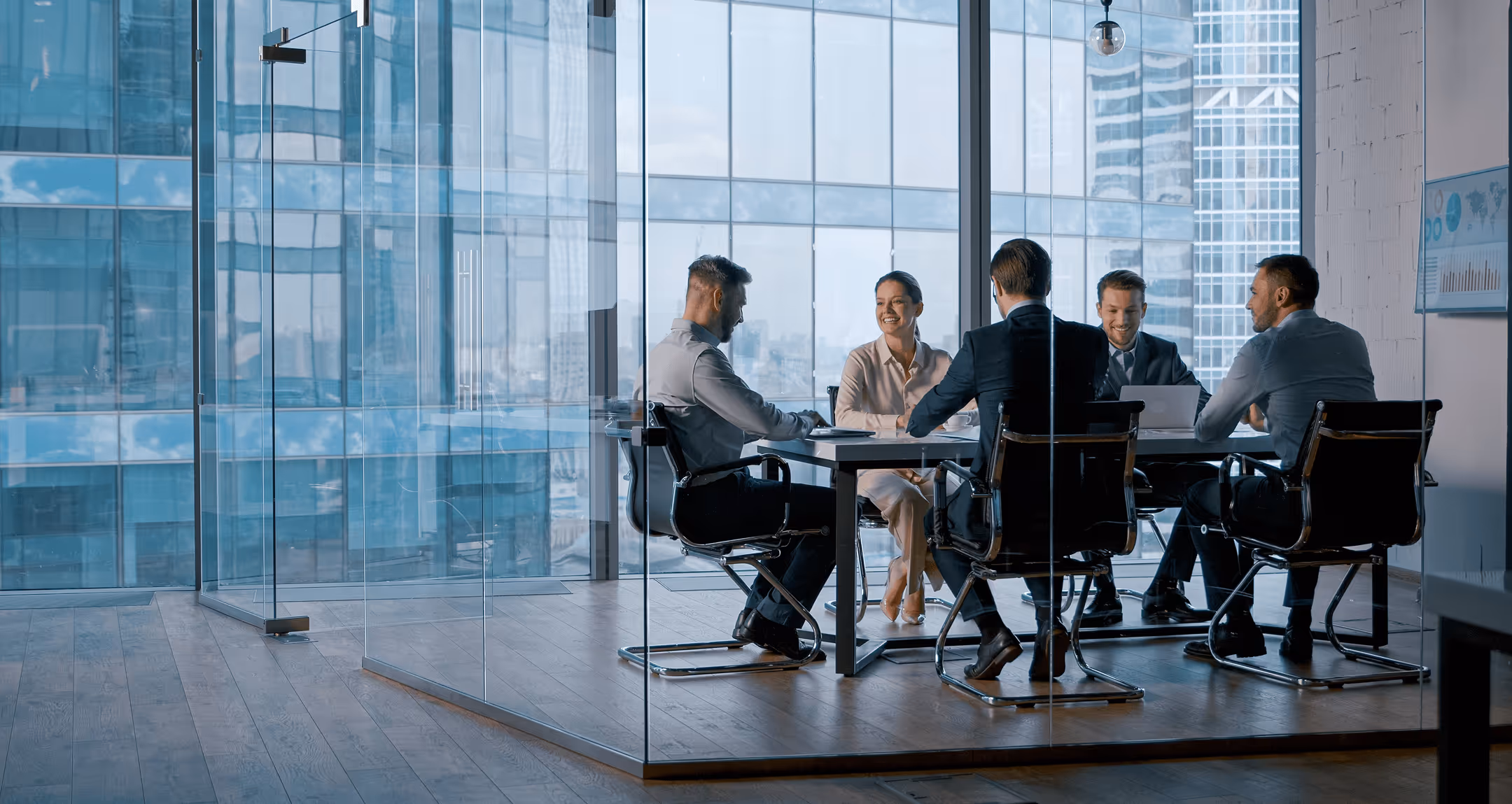 Executive team meeting in a modern office, reflecting institutional investment management strategy.