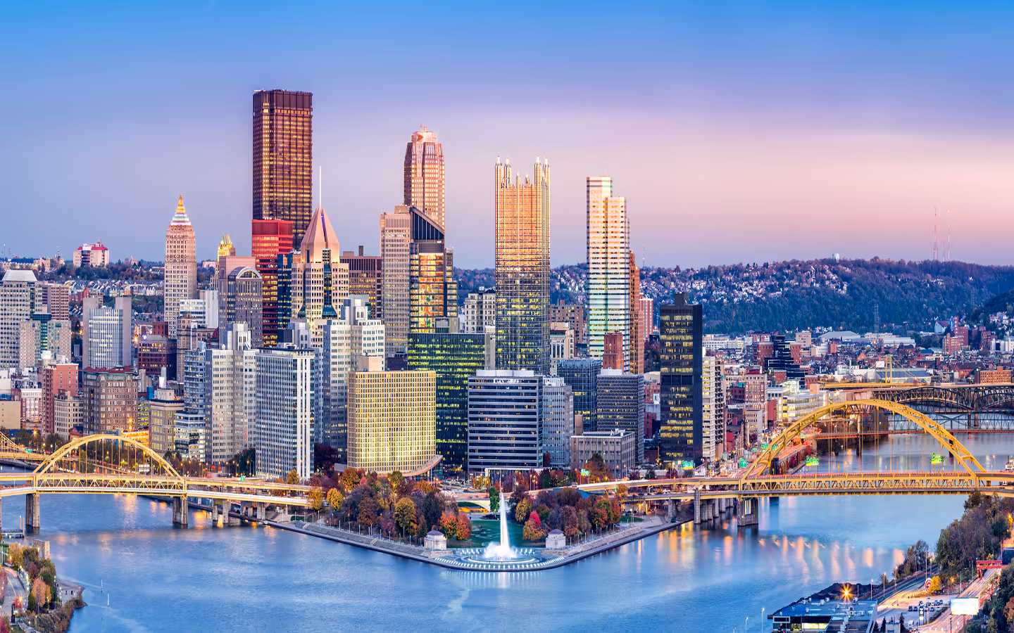 City skyline at dusk with bridges, symbolizing stability and long term private wealth management.
