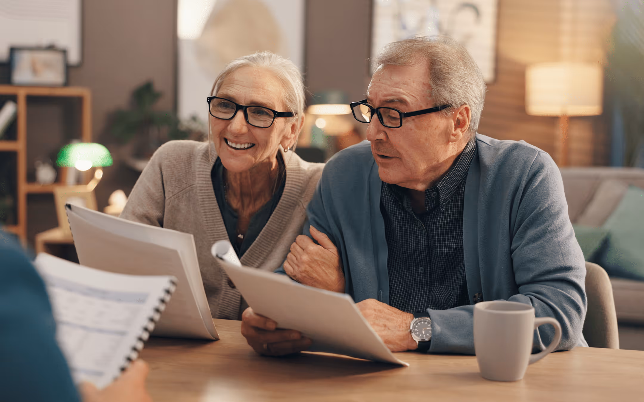 Older couple reviewing paperwork together during a personalized financial planning meeting.