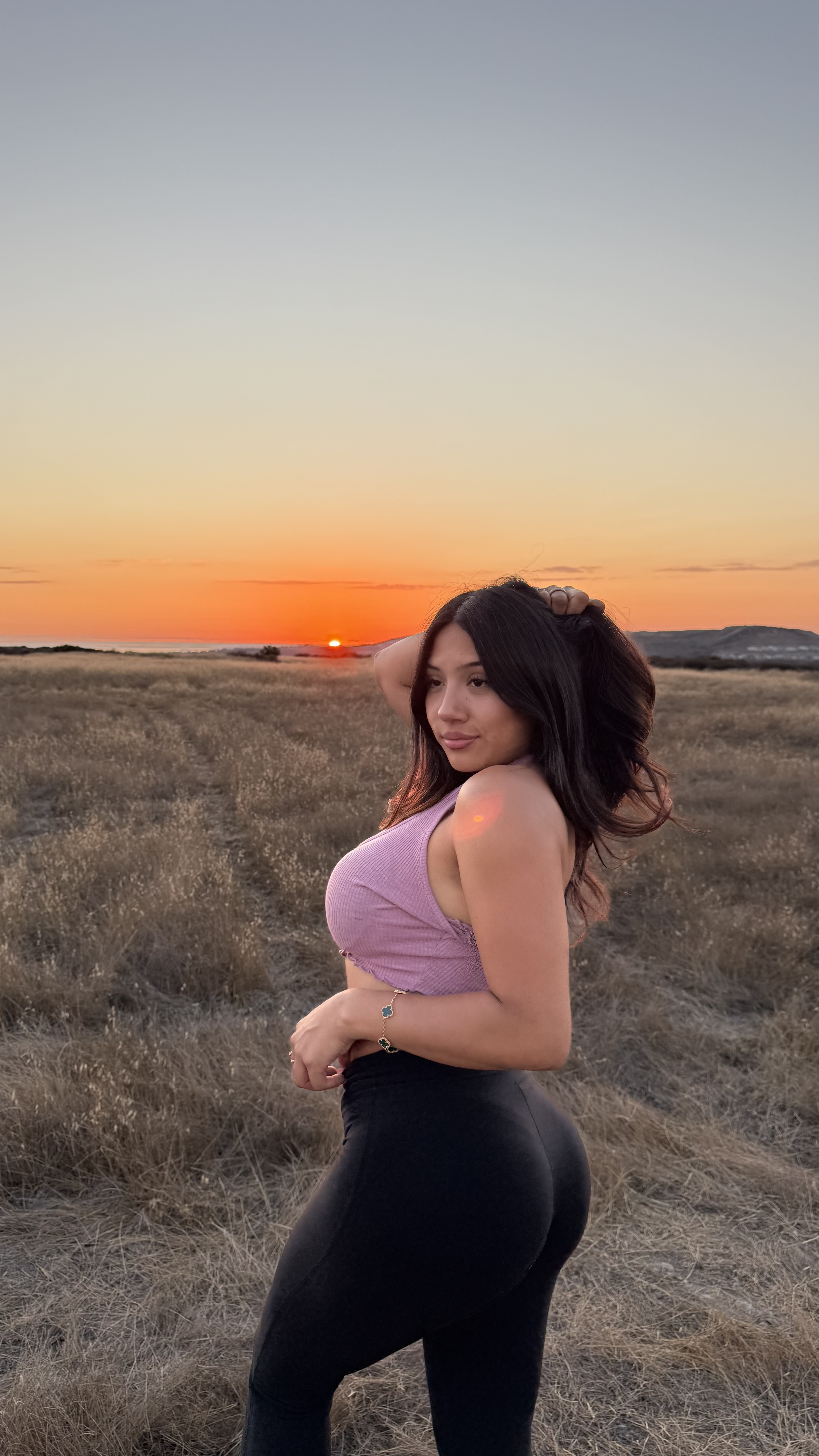 Alessandra Cruz TikTok influencer posing at golden hour in a field - portfolio hero image