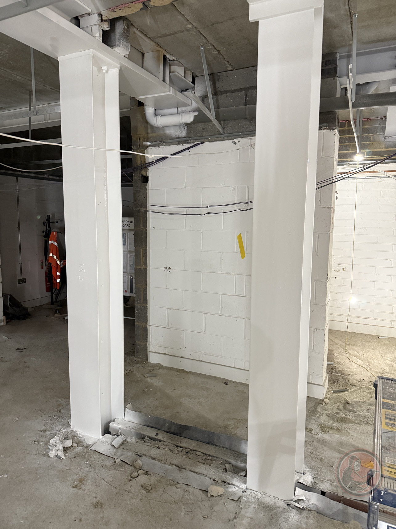 Completed white intumescent-coated beams and columns at Tilbury Community Centre.