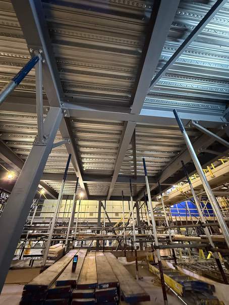 Primed grey steel beams before intumescent application at P&G Tilbury.