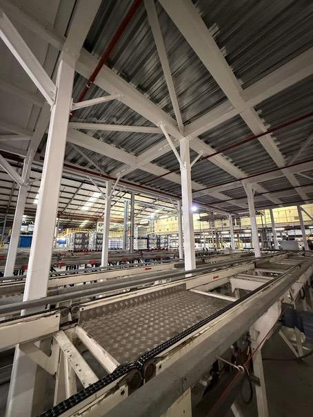 Completed white-coated steel frame above manufacturing equipment at P&G Tilbury.