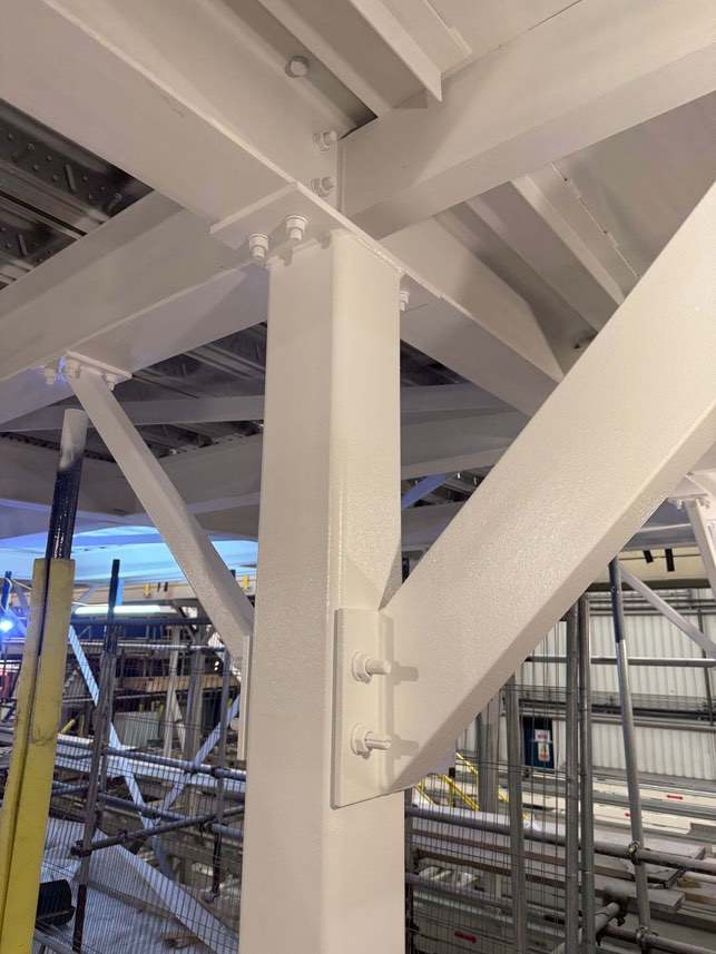 Completed white coating around a bolted column-to-beam connection.