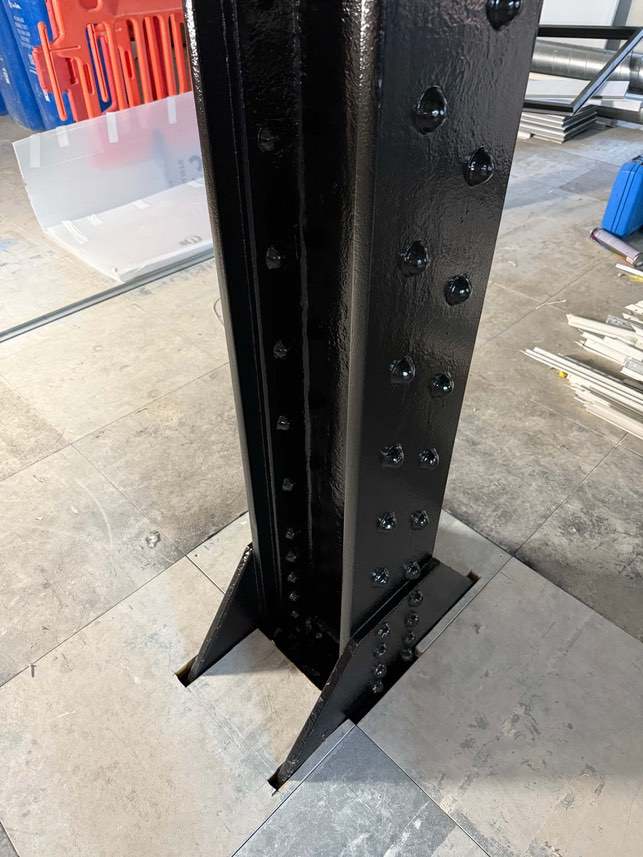 Close-up of the black-finished riveted steel column base at Devonshire House.