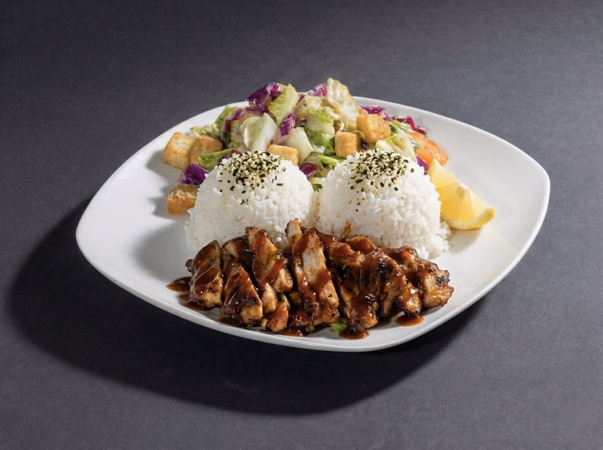 Plate with grilled honey BBQ chicken, two servings of white rice, and a fresh salad with lettuce, tomato, onion, and ranch dressing.
