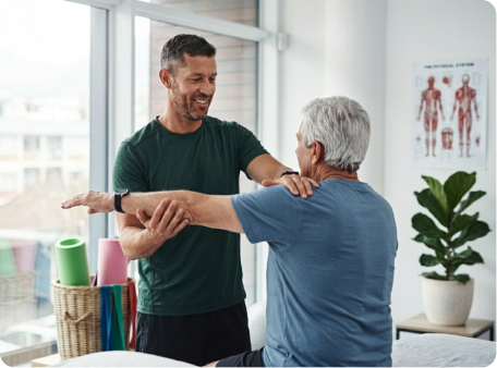 Therapist assisting a patient with a mobility exercise