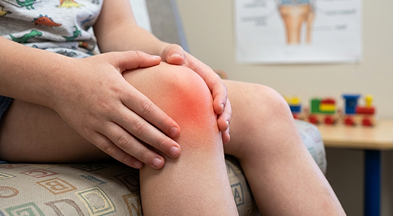 Child holding a painful knee