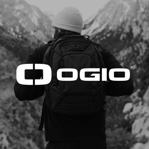 Person wearing a backpack in a mountainous outdoor setting with the OGIO logo overlay.