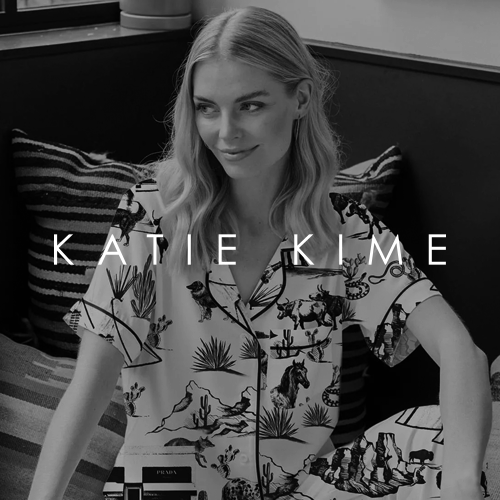 Smiling woman with long blonde hair wearing a patterned button-up shirt sitting on a striped cushion in a cozy indoor setting, with the text 'KATIE KIME' overlayed.